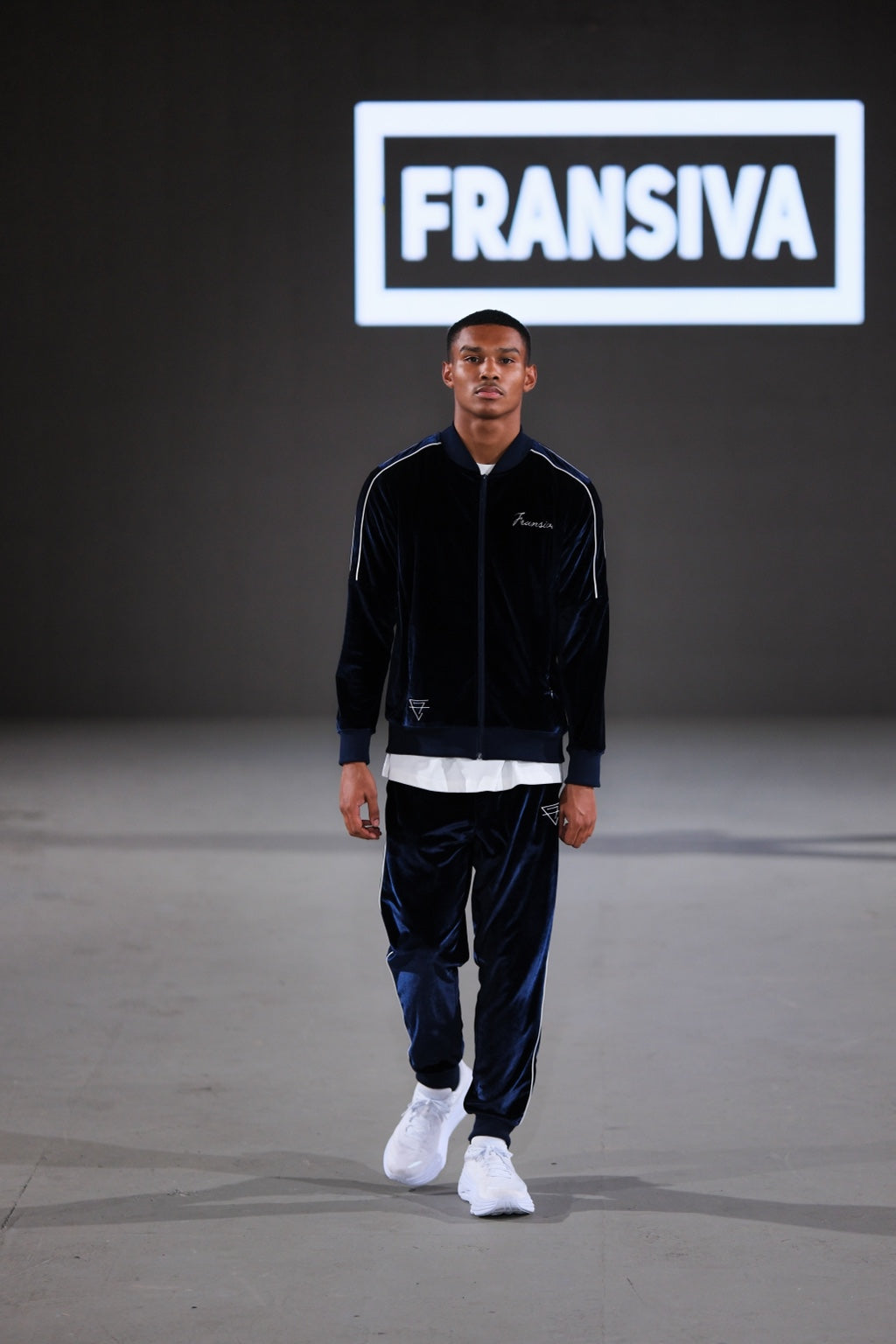 Model wearing a navy FRANSIVA velvet tracksuit at Los Angeles Fashion Week